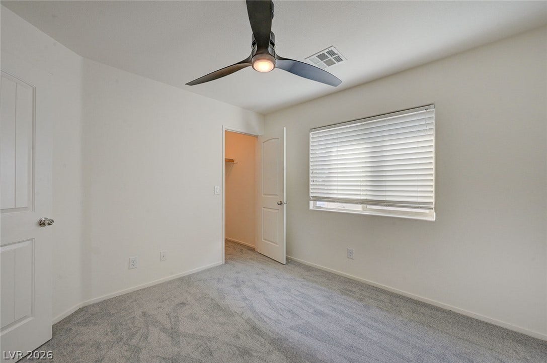 5608 Beckett Hill Court, Las Vegas, NV 89135 Plush carpeting and a wide window with integrated horizontal blinds define this versatile bedroom.