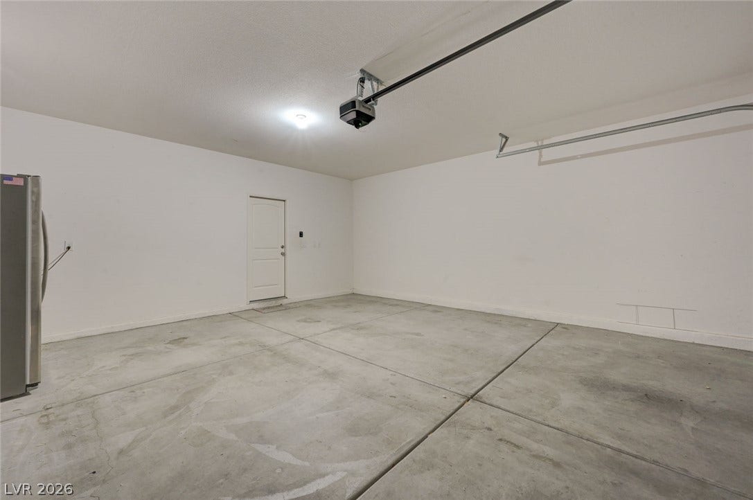 5608 Beckett Hill Court, Las Vegas, NV 89135 An attached two-car garage features durable concrete flooring and an automatic door opener.