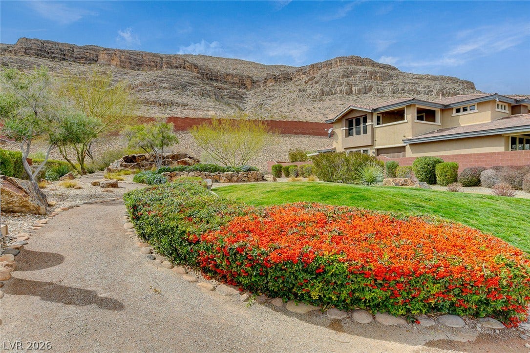 5608 Beckett Hill Court, Las Vegas, NV 89135 Dramatic mountain vistas rise behind the beautifully landscaped backyard oasis.
