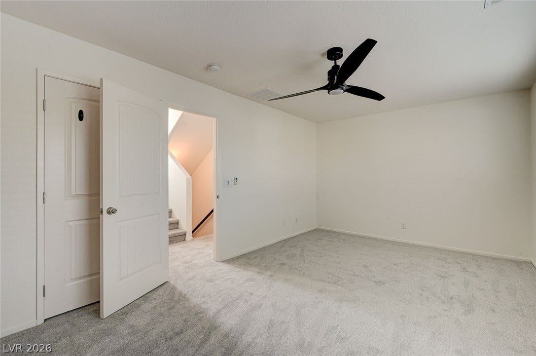 5608 Beckett Hill Court, Las Vegas, NV 89135 Neutral walls and plush carpeting create a quiet retreat adjacent to the staircase.