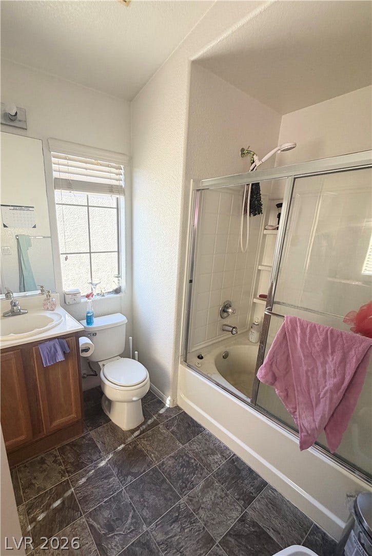 6408 Yucca Ridge Court, North Las Vegas, NV 89084 Tile flooring and a soaking tub with sliding glass doors highlight this bathroom.