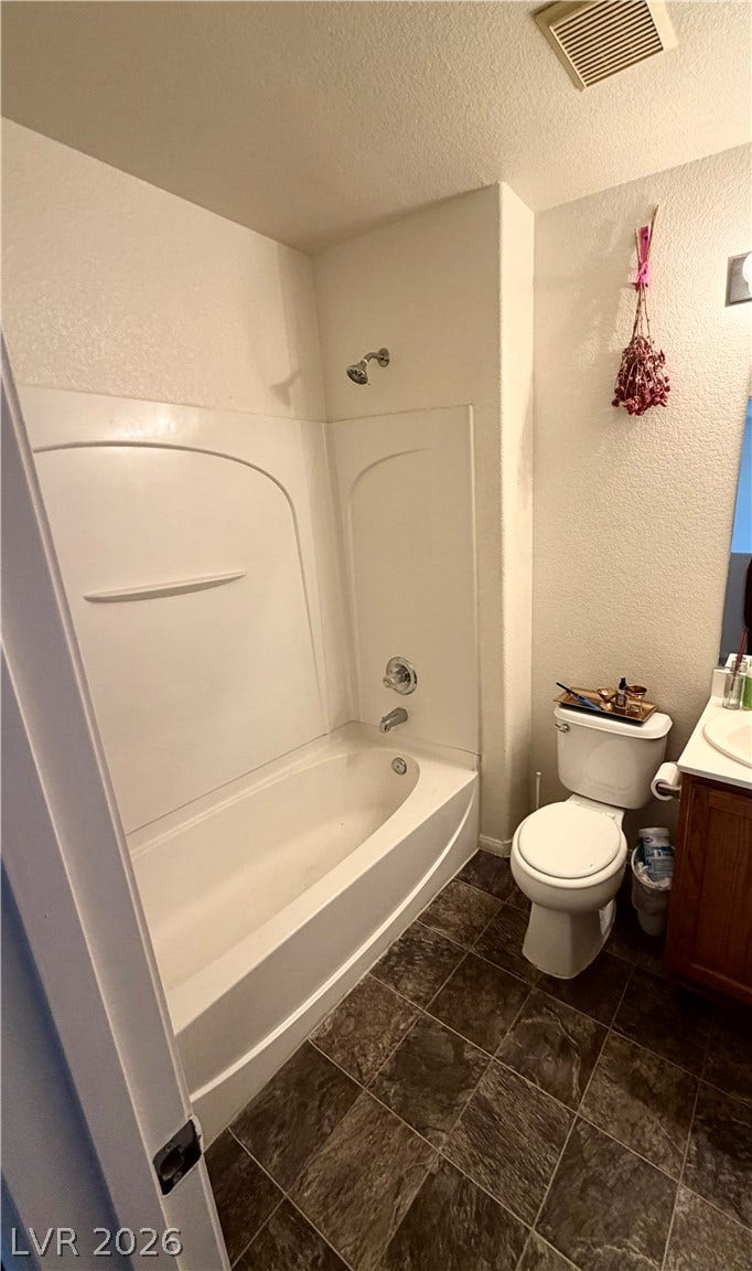 6408 Yucca Ridge Court, North Las Vegas, NV 89084 Tile flooring grounds this functional bathroom featuring a tub and shower combination.