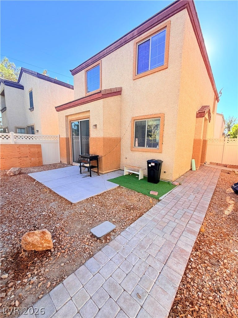 6408 Yucca Ridge Court, North Las Vegas, NV 89084 A paved walkway winds past the concrete patio of this low-maintenance yard.