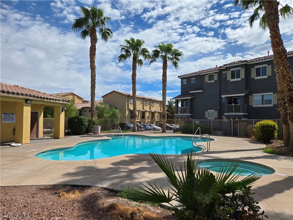 5935 Nuevo Leon Street, #2, North Las Vegas, NV 89031 Towering palm trees frame the community swimming pool and adjacent spa.