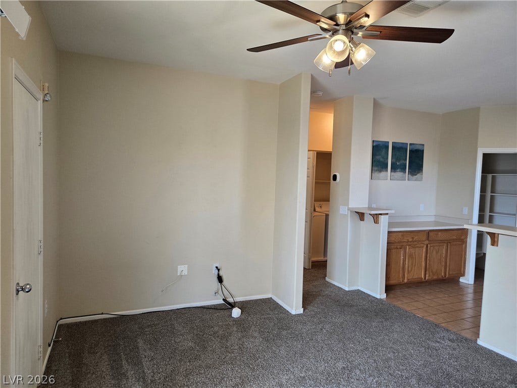 5935 Nuevo Leon Street, #2, North Las Vegas, NV 89031 Plush carpeting and an open layout connect the versatile living space to the adjacent kitchen.