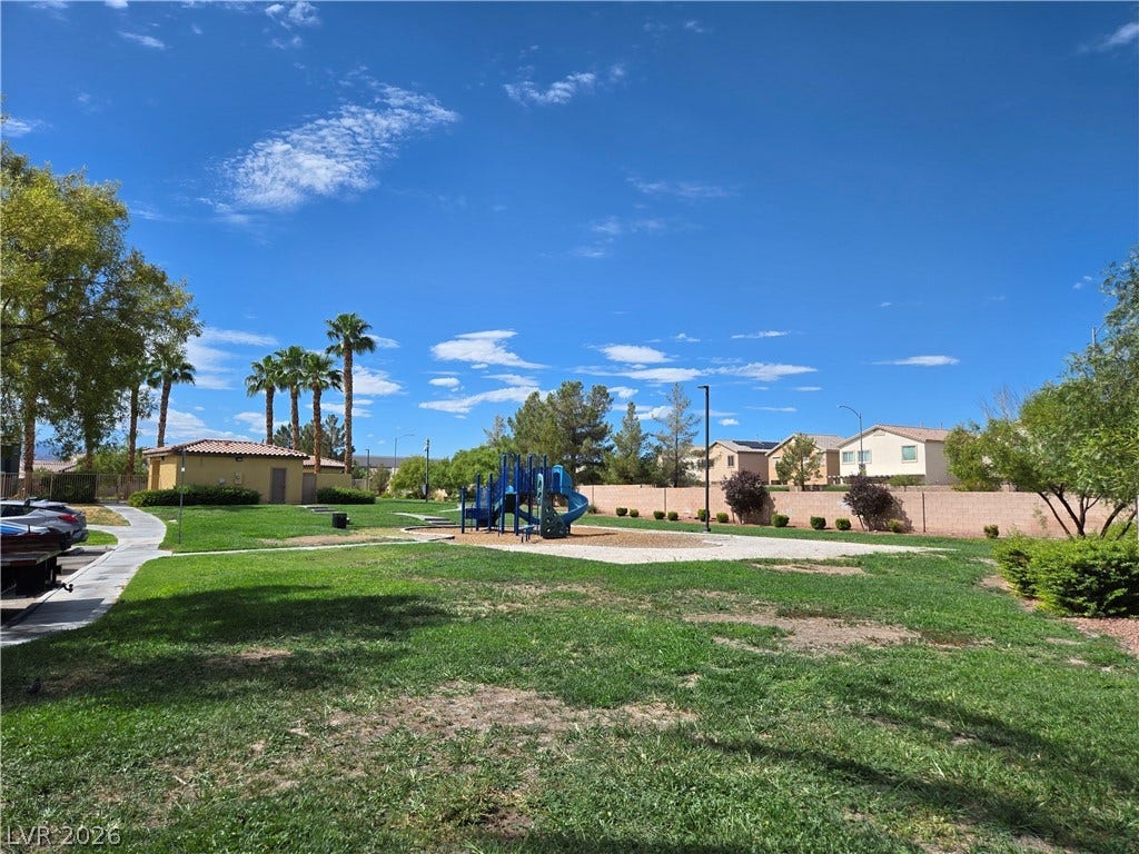 5935 Nuevo Leon Street, #2, North Las Vegas, NV 89031 Green lawn surrounds a playground set under clear blue skies in this neighborhood park.
