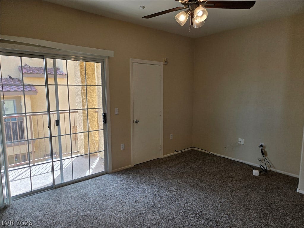 5935 Nuevo Leon Street, #2, North Las Vegas, NV 89031 Sliding glass doors open directly to a private balcony from this carpeted bedroom.