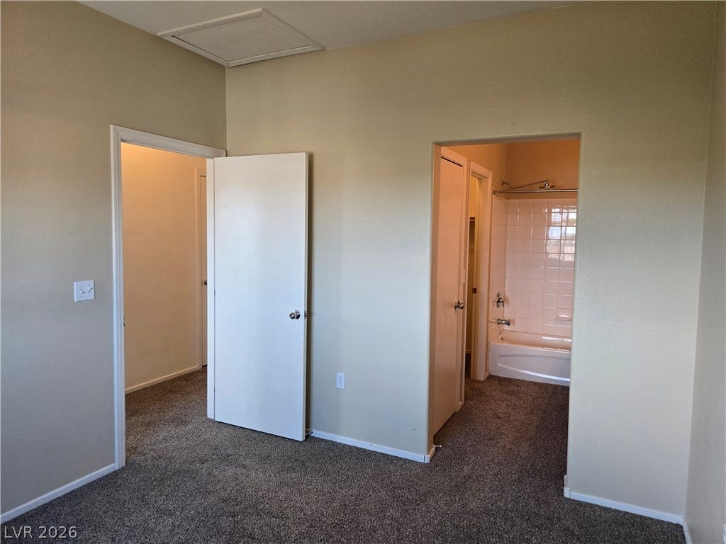 5935 Nuevo Leon Street, #2, North Las Vegas, NV 89031 An adjoining bathroom and walk-in closet connect directly to this carpeted bedroom suite.