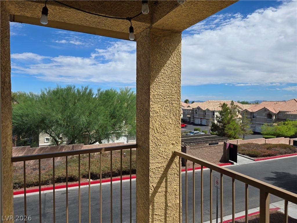 5935 Nuevo Leon Street, #2, North Las Vegas, NV 89031 An elevated perspective looks out over the surrounding neighborhood from a covered stucco balcony.