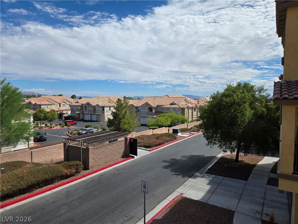 5935 Nuevo Leon Street, #2, North Las Vegas, NV 89031 Scenic neighborhood views stretch across tiled rooftops under a wide desert sky.