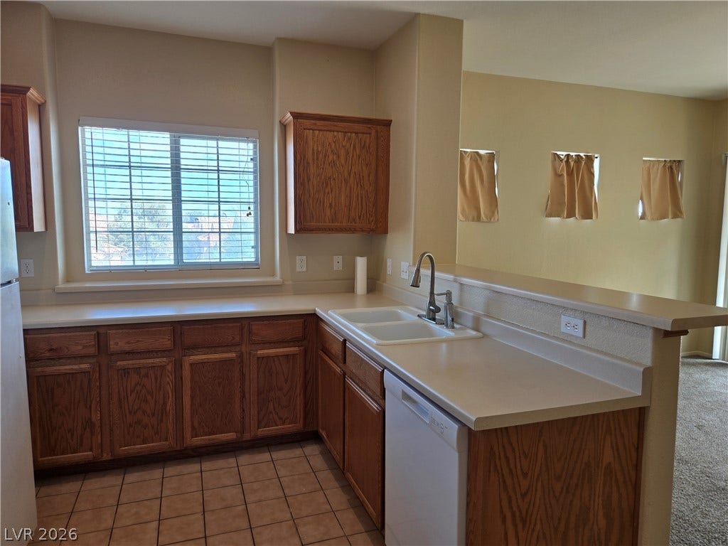 5935 Nuevo Leon Street, #2, North Las Vegas, NV 89031 Ample counter space and classic cabinetry define this functional kitchen area.