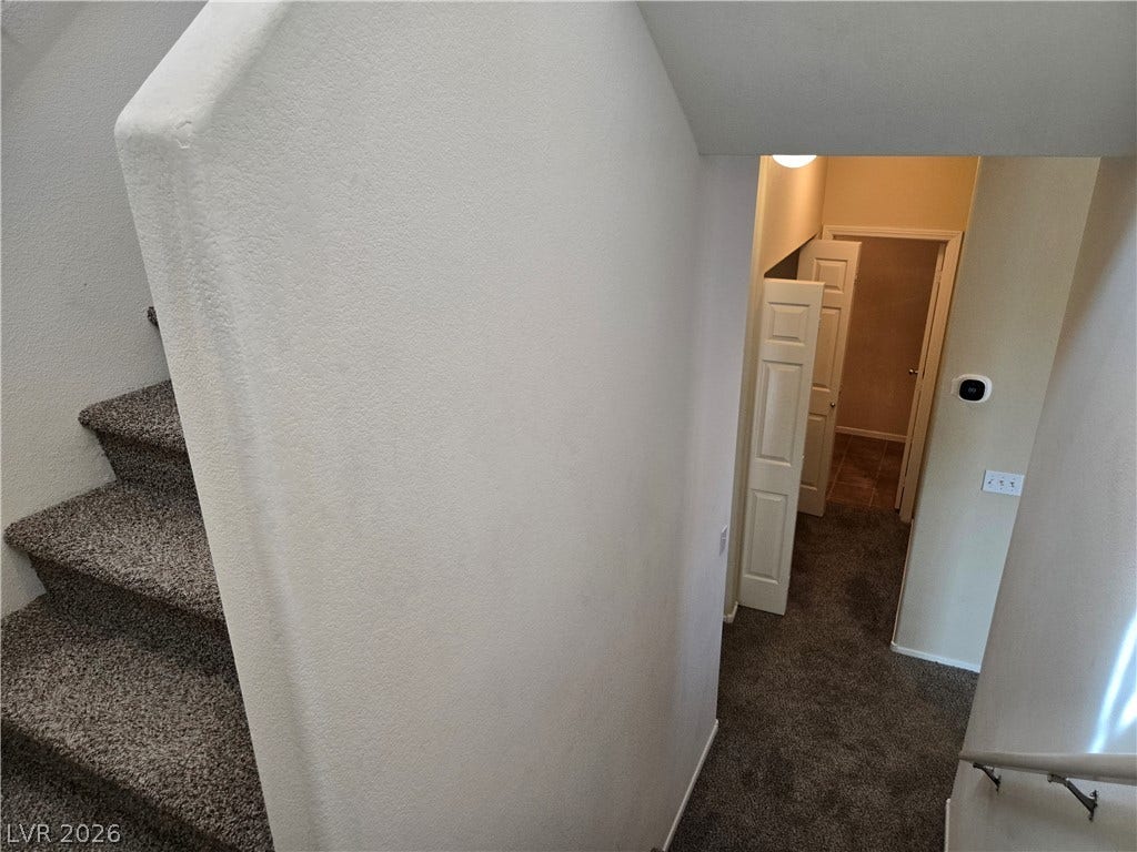 5935 Nuevo Leon Street, #2, North Las Vegas, NV 89031 Carpeted stairs connect multiple living levels within this functional layout.