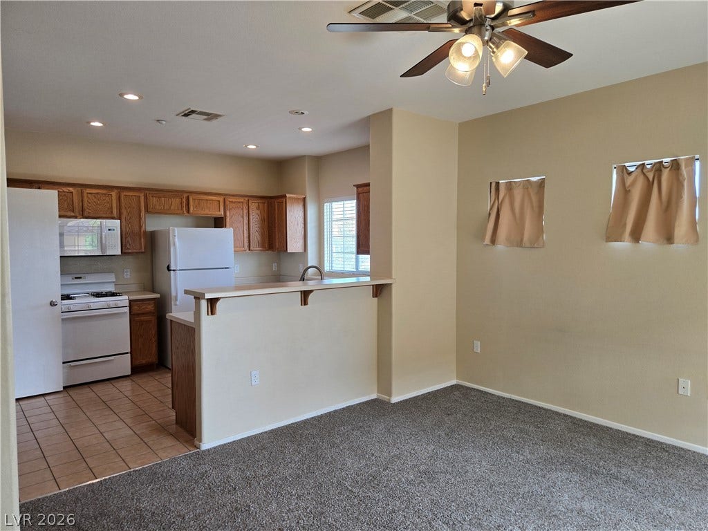 5935 Nuevo Leon Street, #2, North Las Vegas, NV 89031 Tiled kitchen flooring transitions seamlessly to carpet in the open dining area.