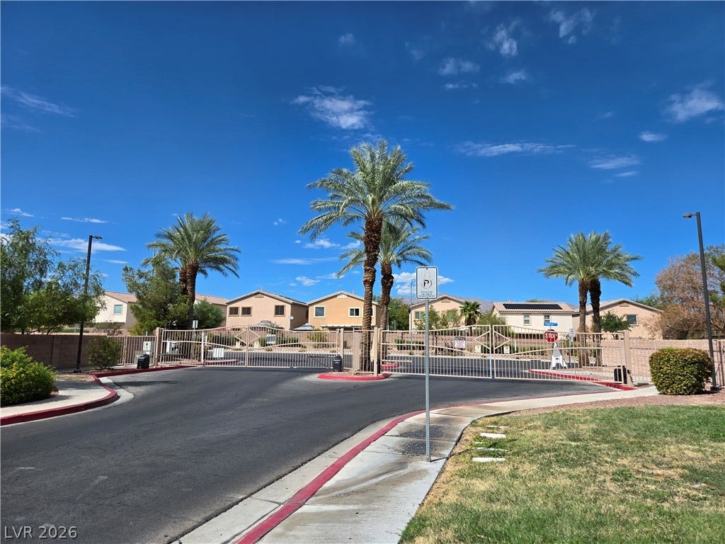 5935 Nuevo Leon Street, #2, North Las Vegas, NV 89031 Secure gated access provides entry to a neighborhood of classic desert-style homes under open skies.