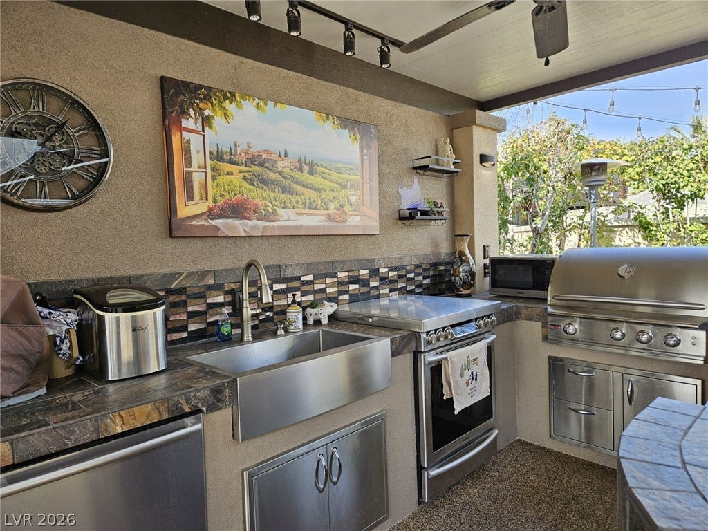 8175 Arville Street, #287, Las Vegas, NV 89139 A fully equipped outdoor kitchen features extensive stone tile countertops and integrated stainless steel appliances.