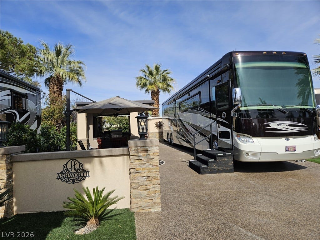 8175 Arville Street, #287, Las Vegas, NV 89139 A spacious paved motorcoach lot features a stone-accented privacy wall and palm tree backdrop.