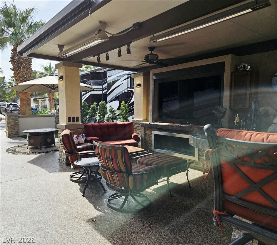 8175 Arville Street, #287, Las Vegas, NV 89139 Sheltered outdoor living space features a stone fireplace under a finished ceiling.