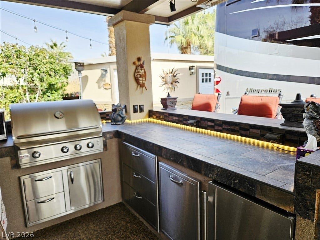 8175 Arville Street, #287, Las Vegas, NV 89139 Sheltered outdoor kitchen provides tile countertops and a built-in stainless steel grill for seamless entertaining.