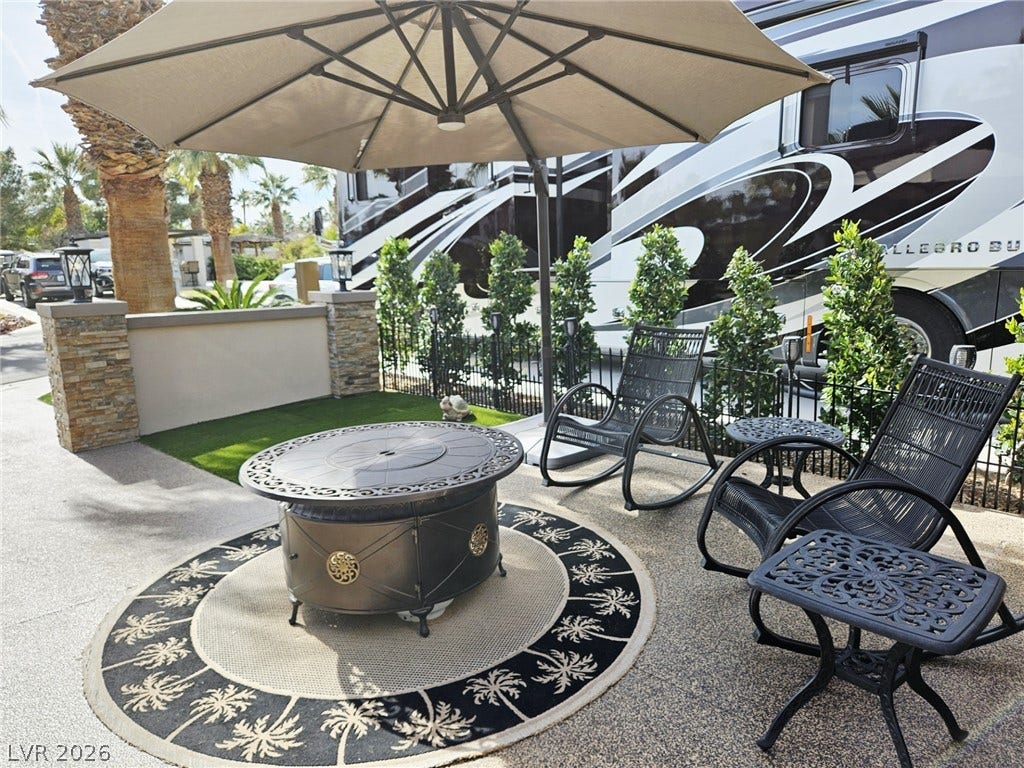 8175 Arville Street, #287, Las Vegas, NV 89139 An inviting outdoor patio space features a built-in stone wall, paved flooring, and gated fencing.