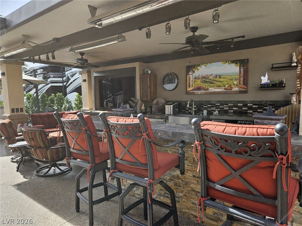 8175 Arville Street, #287, Las Vegas, NV 89139 An inviting covered patio bar includes a stone-accented counter and overhead track lighting.