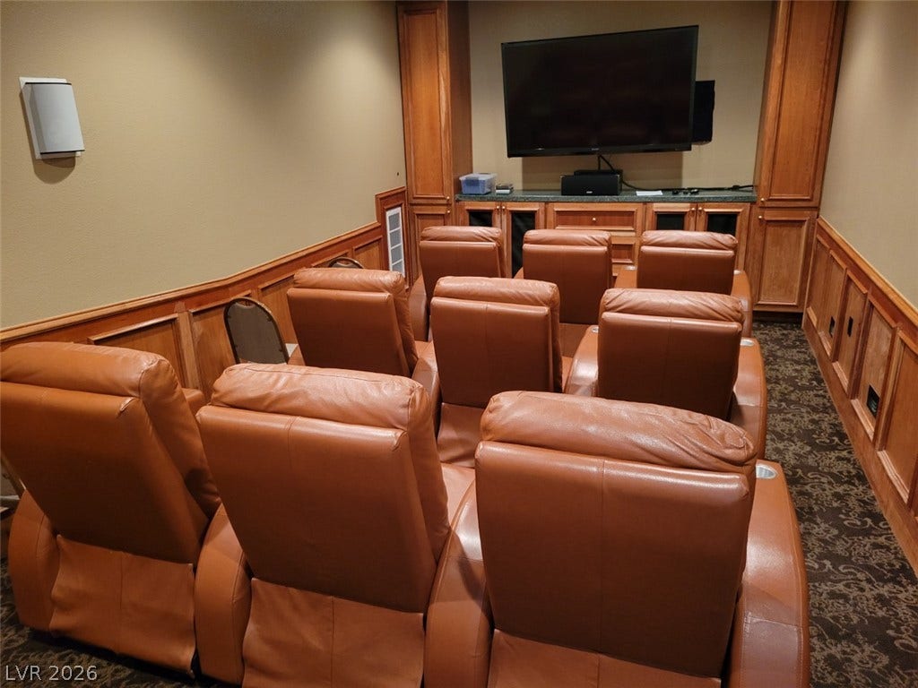 8175 Arville Street, #287, Las Vegas, NV 89139 Rich wood paneling and custom built-ins frame this comfortable private home theater room.
