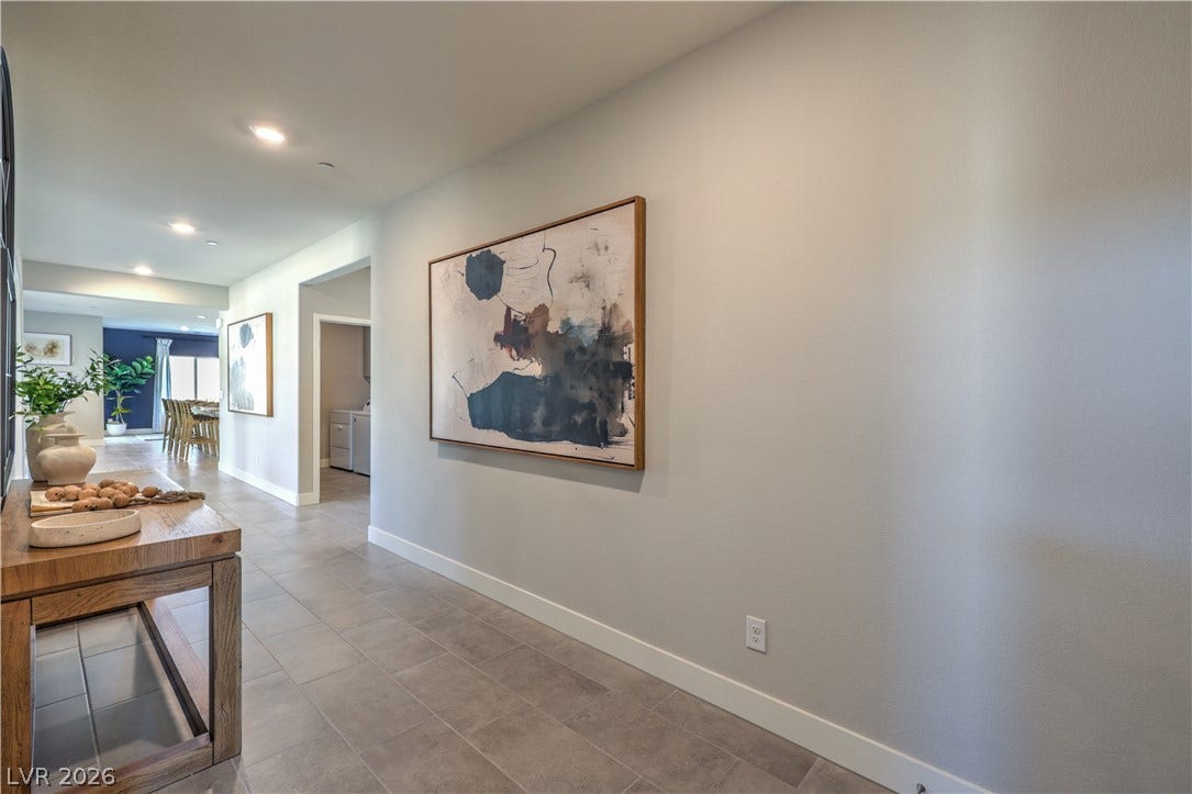 1044 Gentle Swan Street, Henderson, NV 89011 Gleaming tile floors line a spacious entryway leading into the heart of the home.