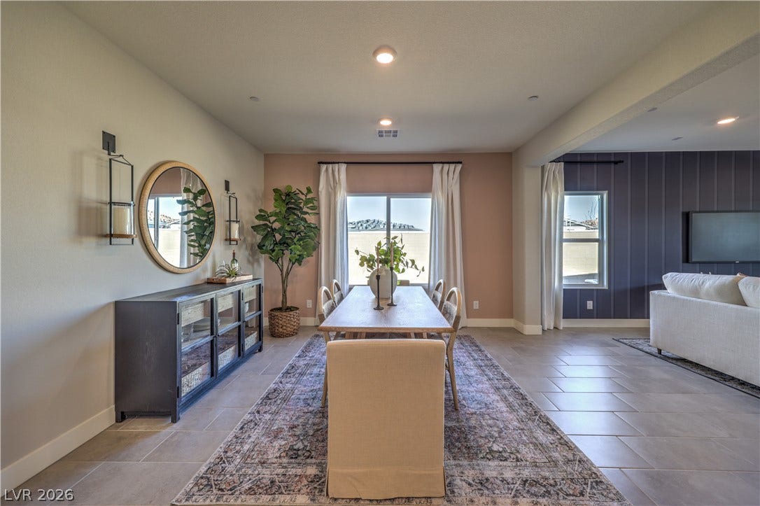 1044 Gentle Swan Street, Henderson, NV 89011 An open floorplan seamlessly connects the dining space to the adjoining living areas. Photo is of actual model home for sale.