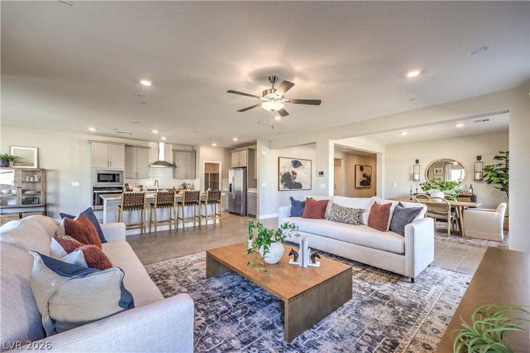 1044 Gentle Swan Street, Henderson, NV 89011 An open floorplan seamlessly connects the comfortable living area to the kitchen and dining spaces. Photo is of actual model home for sale.