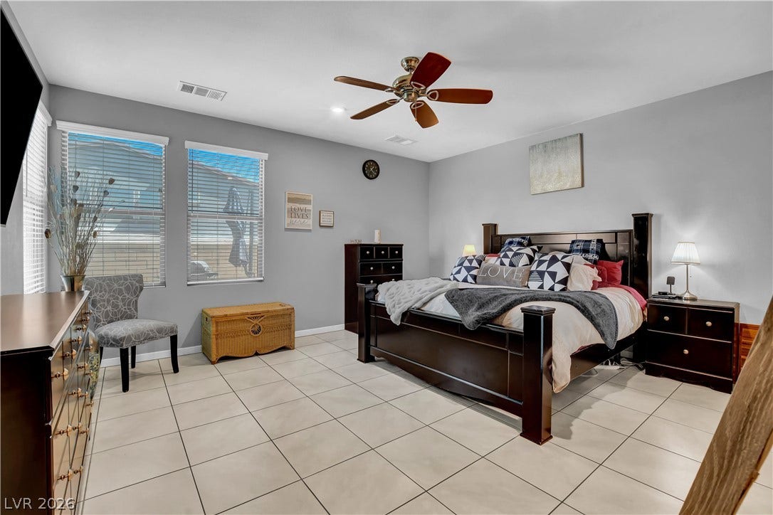 6834 Moorland Street, North Las Vegas, NV 89084 Tiled flooring and large windows create a clean foundation in this spacious bedroom.