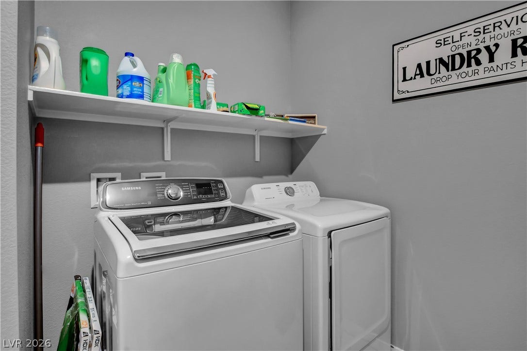 6834 Moorland Street, North Las Vegas, NV 89084 Functional laundry space equipped with a handy overhead storage shelf.