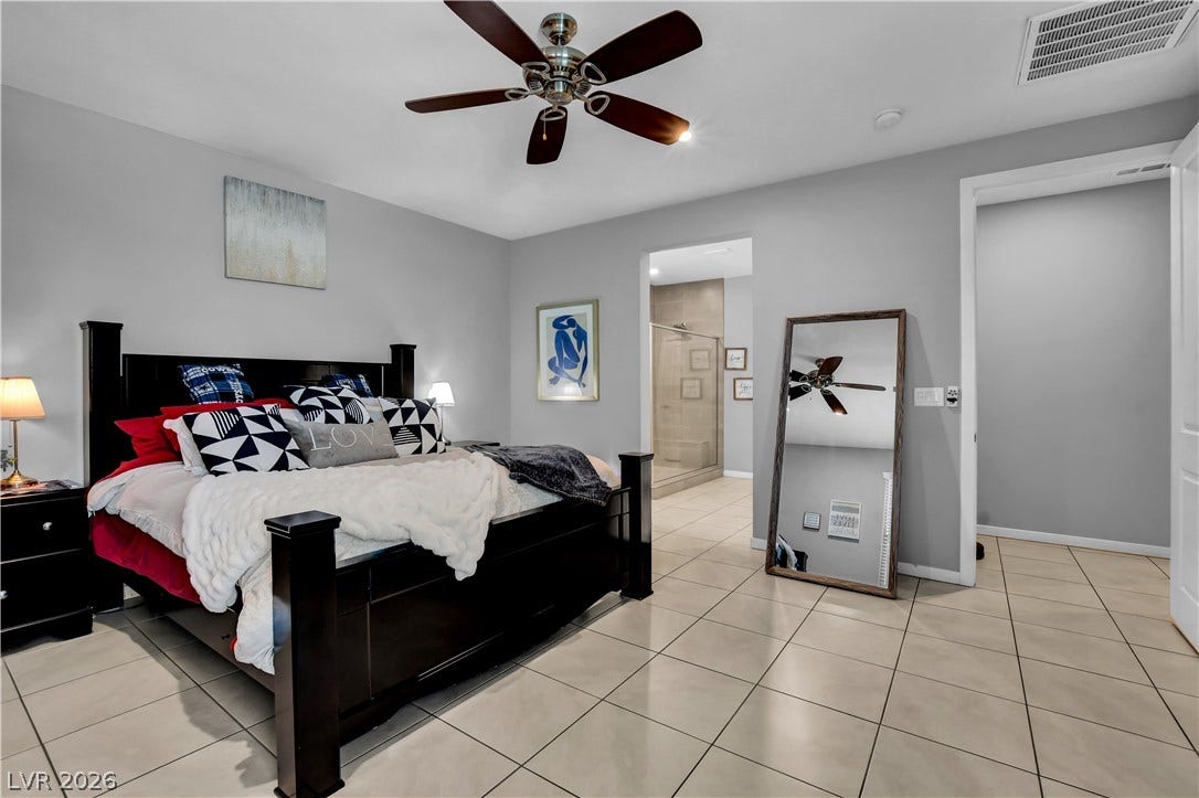 6834 Moorland Street, North Las Vegas, NV 89084 Tiled flooring and neutral walls define this peaceful bedroom retreat with an attached bath.