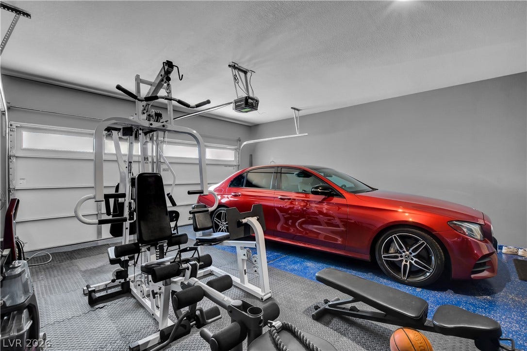 6834 Moorland Street, North Las Vegas, NV 89084 An accommodating multi-car garage provides extensive space for utility, vehicles, and flexible storage options.