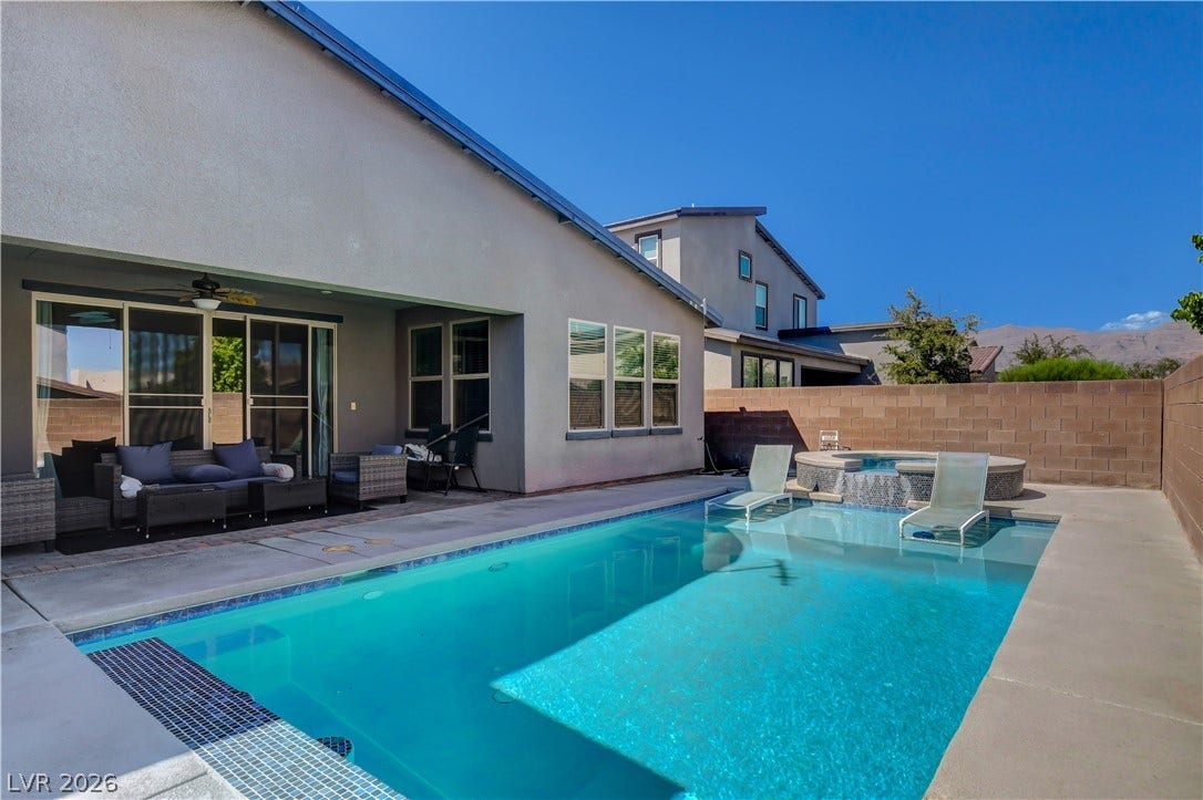 6834 Moorland Street, North Las Vegas, NV 89084 An inviting backyard oasis features a sparkling swimming pool paired with an integrated elevated spa.