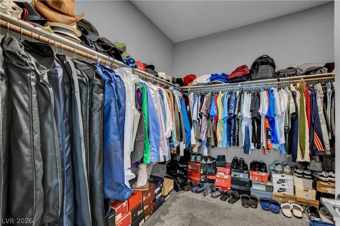 6834 Moorland Street, North Las Vegas, NV 89084 An organized walk-in closet boasts abundant hanging rods and soft carpeting underfoot.
