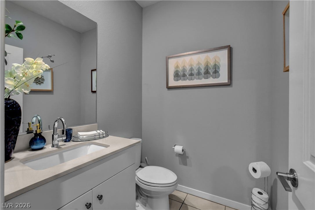 6834 Moorland Street, North Las Vegas, NV 89084 Smooth surfaces and simple lines define this clean powder room.