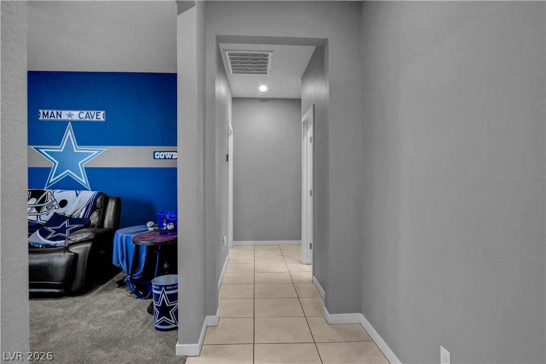 6834 Moorland Street, North Las Vegas, NV 89084 A tiled hallway connects the main living areas with recessed lighting overhead.