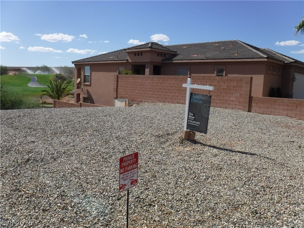 654 Paloma Circle, Mesquite, NV 89027 A classic desert facade overlooks the lush green fairways of an adjacent golf course.