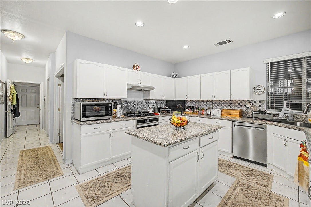 7741 Crenshaw Way, Las Vegas, NV 89129 Gleaming granite countertops and classic tile flooring define this highly functional culinary space.