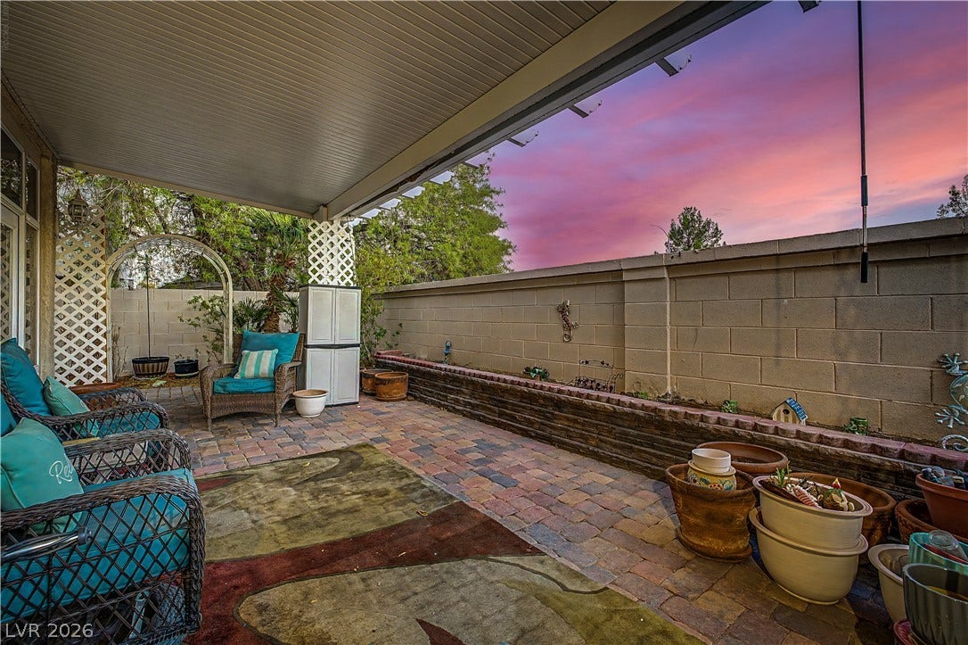 7741 Crenshaw Way, Las Vegas, NV 89129 A spacious covered patio features paver flooring and block privacy walls.