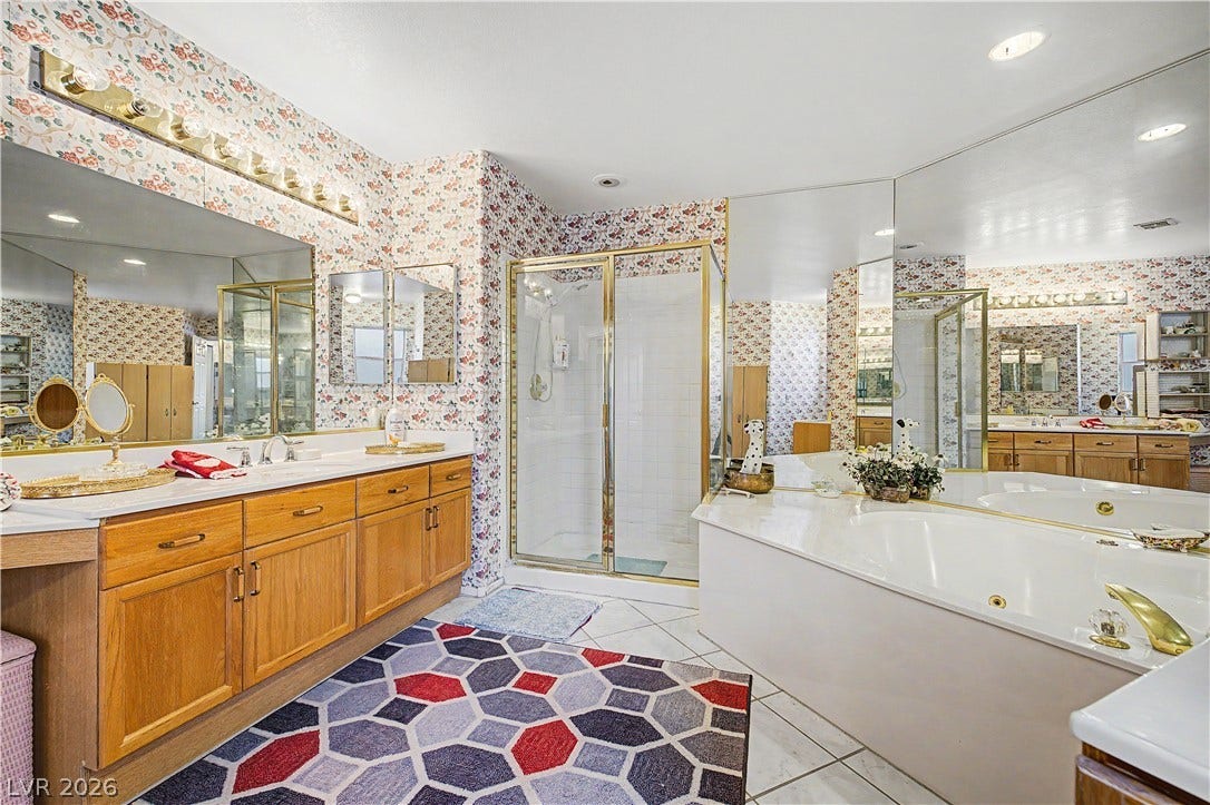7741 Crenshaw Way, Las Vegas, NV 89129 An integrated soaking tub and matching tile flooring anchor this classic full bathroom.