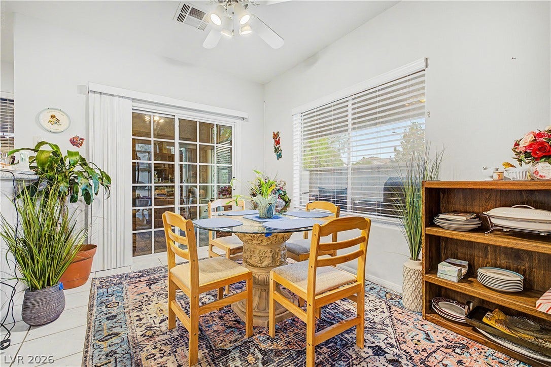7741 Crenshaw Way, Las Vegas, NV 89129 Natural light pours through wide windows and sliding glass doors in this airy dining space.