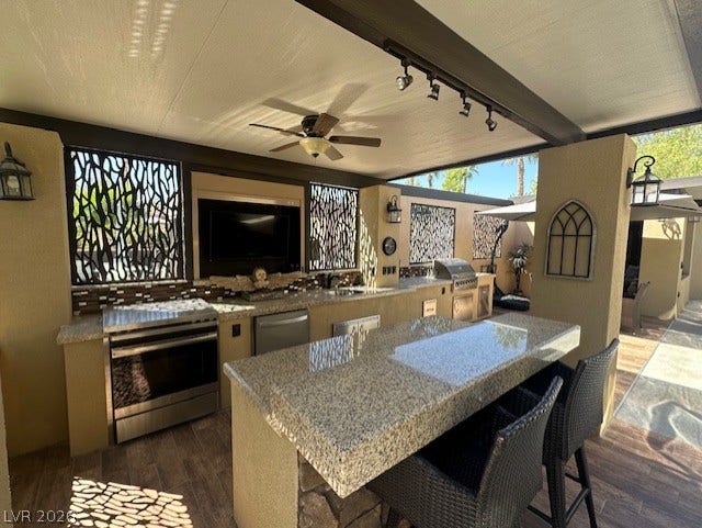 8175 Arville Street, #133, Las Vegas, NV 89139 An outdoor kitchen features granite countertops under a covered patio structure.