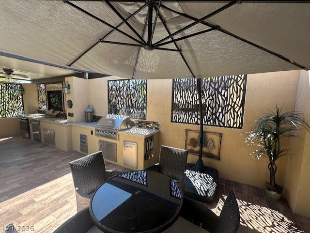 8175 Arville Street, #133, Las Vegas, NV 89139 An outdoor kitchen is seamlessly integrated into this covered patio with stone countertops.