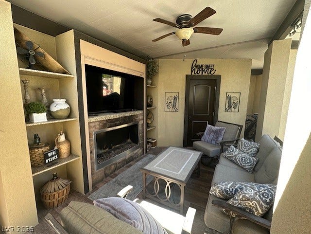 8175 Arville Street, #133, Las Vegas, NV 89139 A stone fireplace anchors this covered patio featuring built-in shelving and tile flooring.