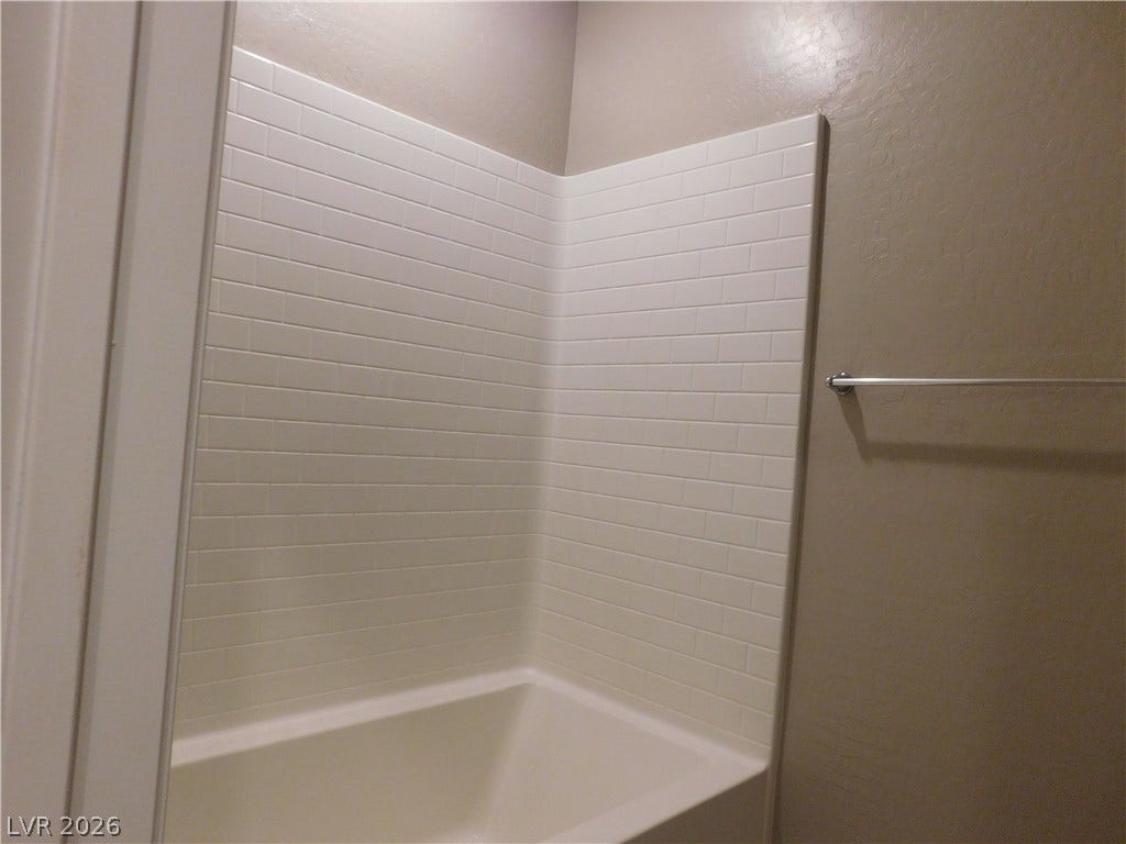 2715 Amazing Meadows Avenue, #1185, North Las Vegas, NV 89031 Crisp subway tile surrounds this deep bathtub setup, ready for relaxation.