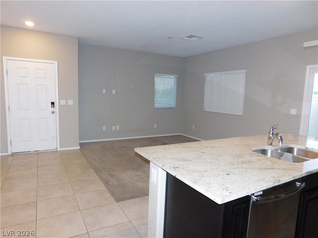 2715 Amazing Meadows Avenue, #1185, North Las Vegas, NV 89031 An open floorplan design seamlessly connects the tiled entry to the carpeted living space.