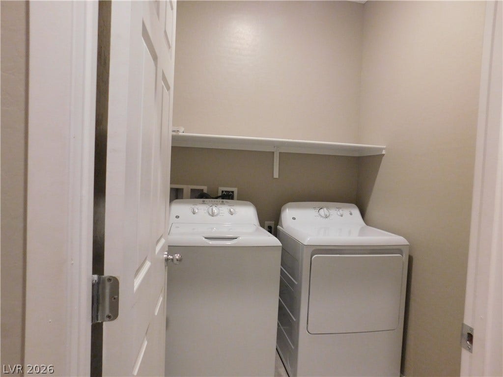 2715 Amazing Meadows Avenue, #1185, North Las Vegas, NV 89031 Functional laundry setup highlights a dedicated utility space with built-in storage shelving.