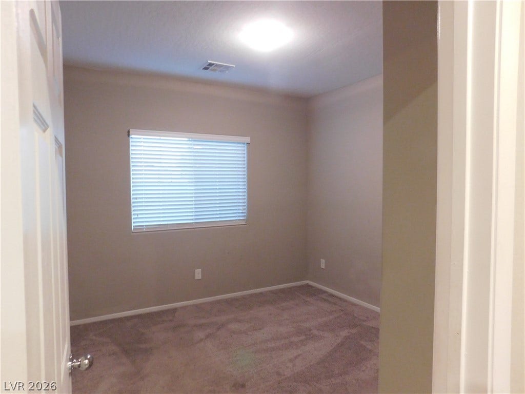 2715 Amazing Meadows Avenue, #1185, North Las Vegas, NV 89031 Plush wall-to-wall carpeting and neutral tones define this versatile secondary bedroom space.