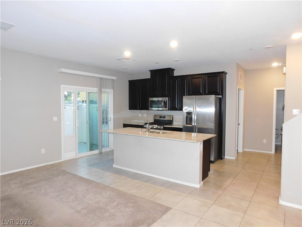 2715 Amazing Meadows Avenue, #1185, North Las Vegas, NV 89031 An open kitchen layout transitions smoothly into the adjoining living space via tile flooring.