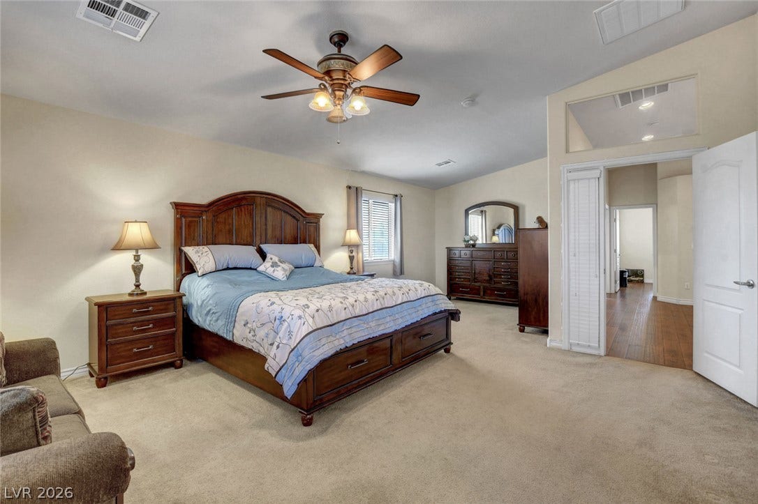 5508 Meridian Rain Street, North Las Vegas, NV 89031 A spacious bedroom features neutral-toned carpeting and vaulted ceilings.